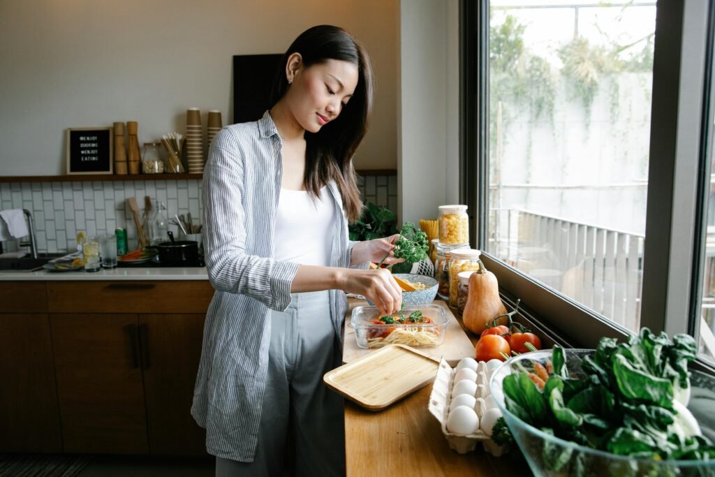 Asian woman preparing a meal to restore pH balance