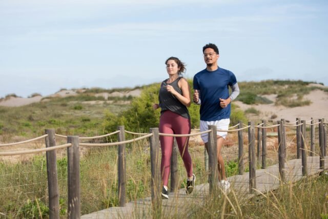 Man and woman jogging by the beach